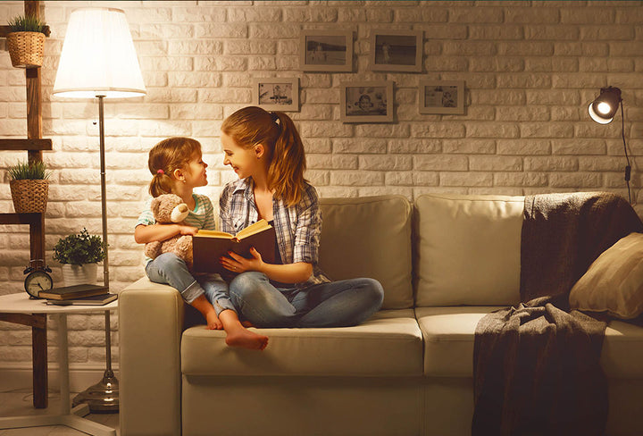 mother and child reading on a couch with kibun lighting